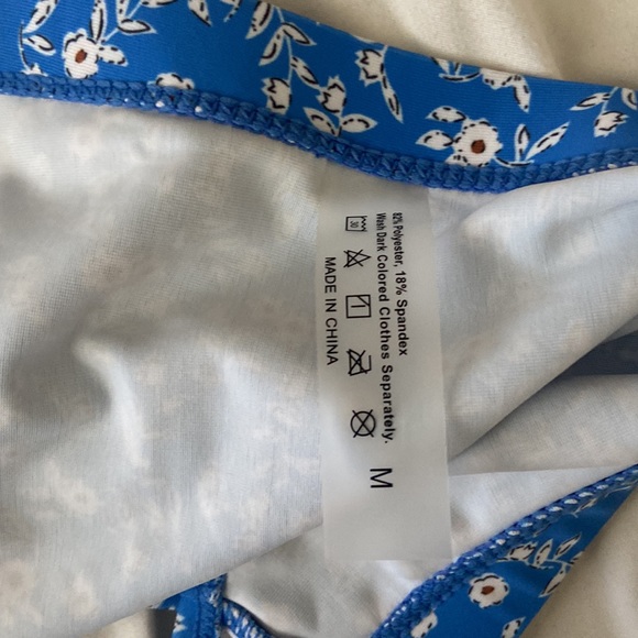 A medium size blue swimsuit with floral design. - Picture 7 of 7